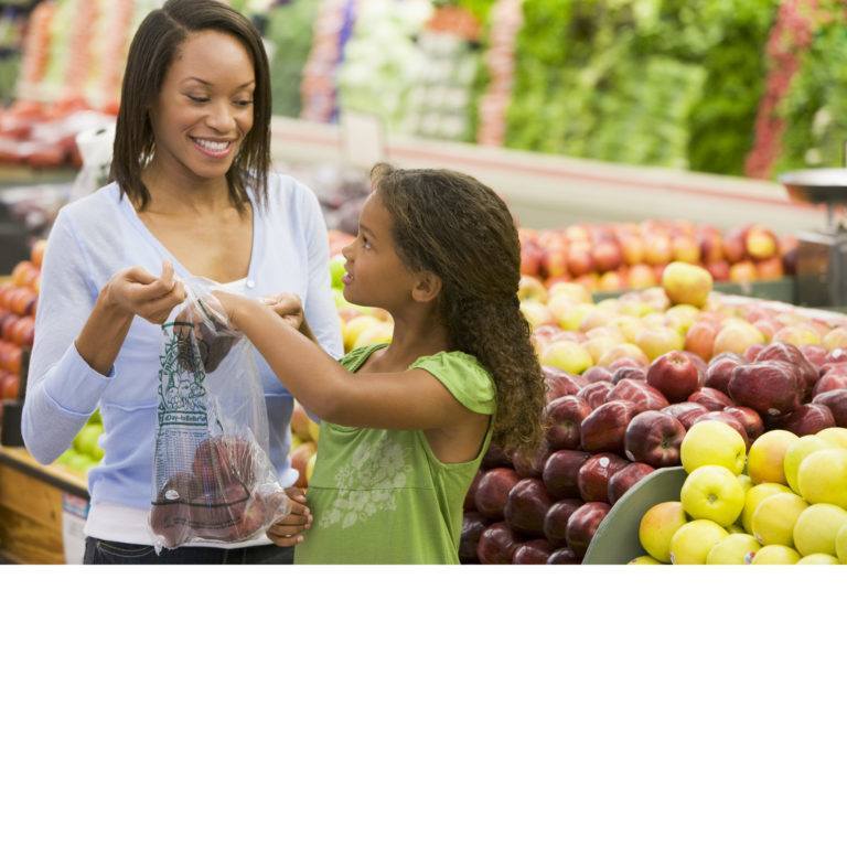 Mother and daughter shopping in produce department